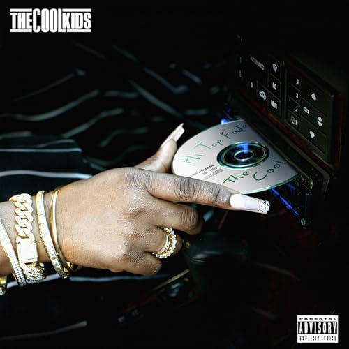 Hand pointing at "Hi Top Fade" vinyl disc in a car stereo.