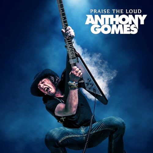 Anthony Gomes playing a black V-shaped electric guitar, album cover.