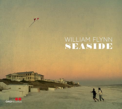 CD cover: beach scene with house, people, and kites in sky.