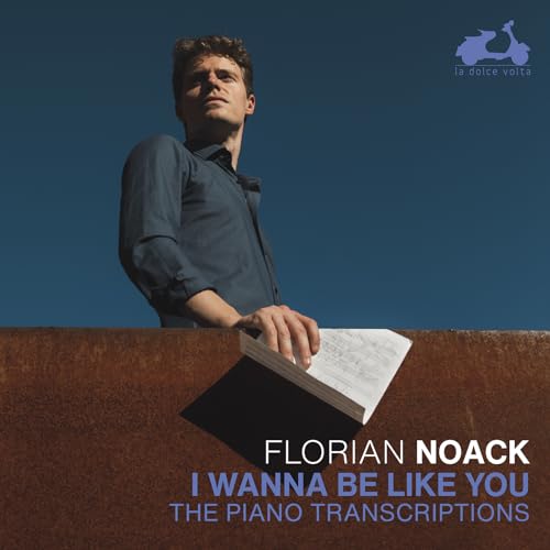 CD cover featuring a man looking up with sheet music and text.