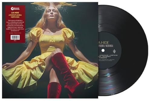 Vinyl record and album cover featuring a woman in a yellow dress.