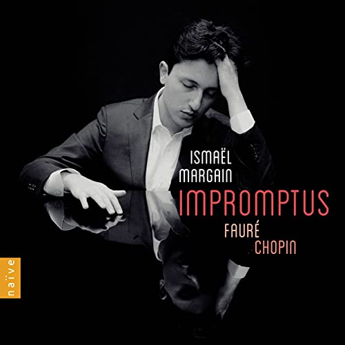 Pianist Ismaël Margain in suit, reflected in a glossy black surface.
