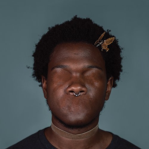 Close-up portrait of a person with eyes closed and a butterfly.