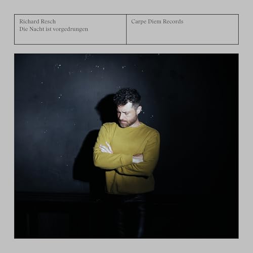 CD cover featuring a man in yellow against a dark background.