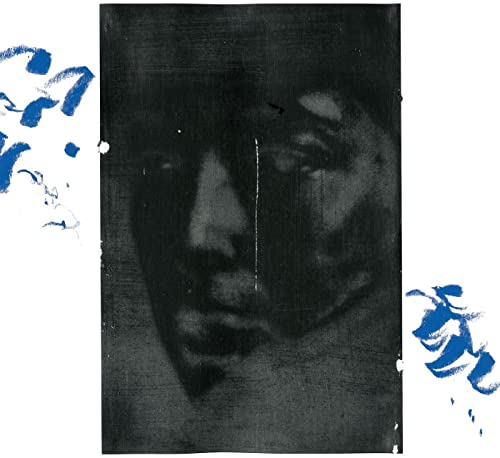 Black and white portrait of a person with blue abstract markings.