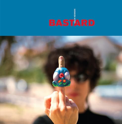 CD cover: hand holding a colorful sculpted figure, blurred background.