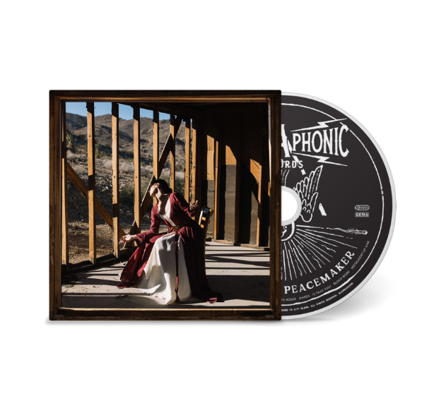 CD case and disc for Sola, Vera’s “Peacemaker” album, with a framed photo.