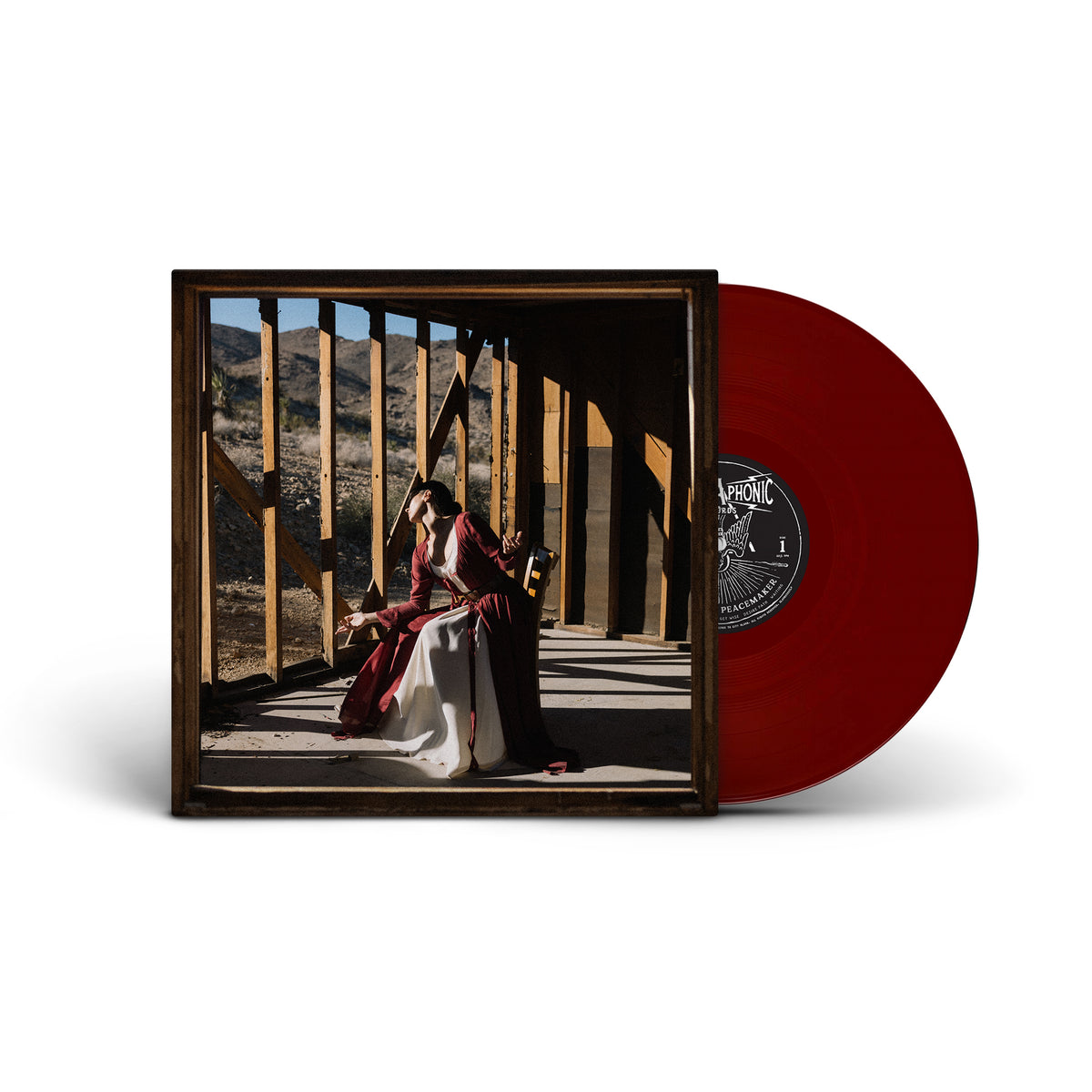 Vinyl record with red oxblood color and album cover featuring a person.