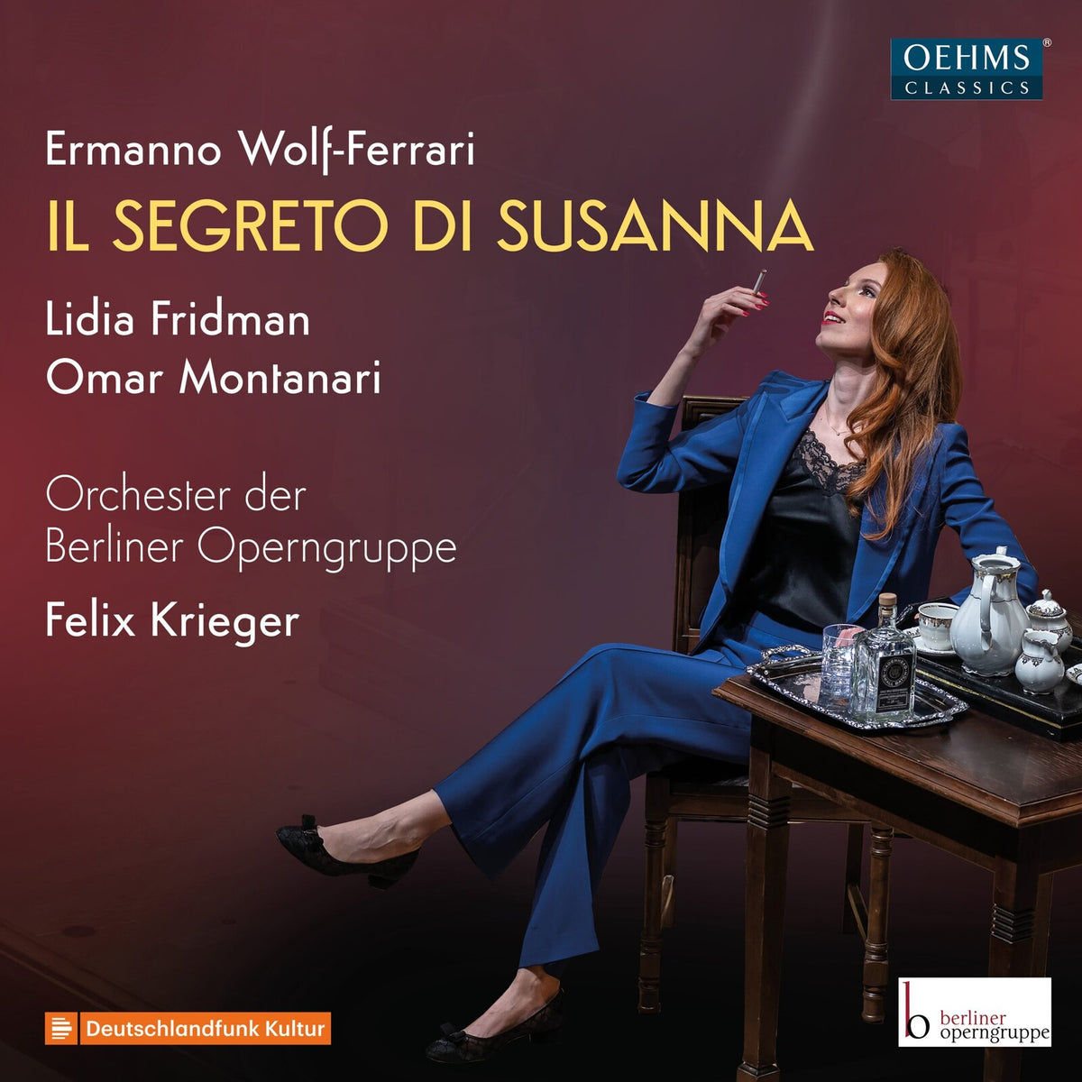 CD cover: red-haired woman in a blue suit seated near a table.