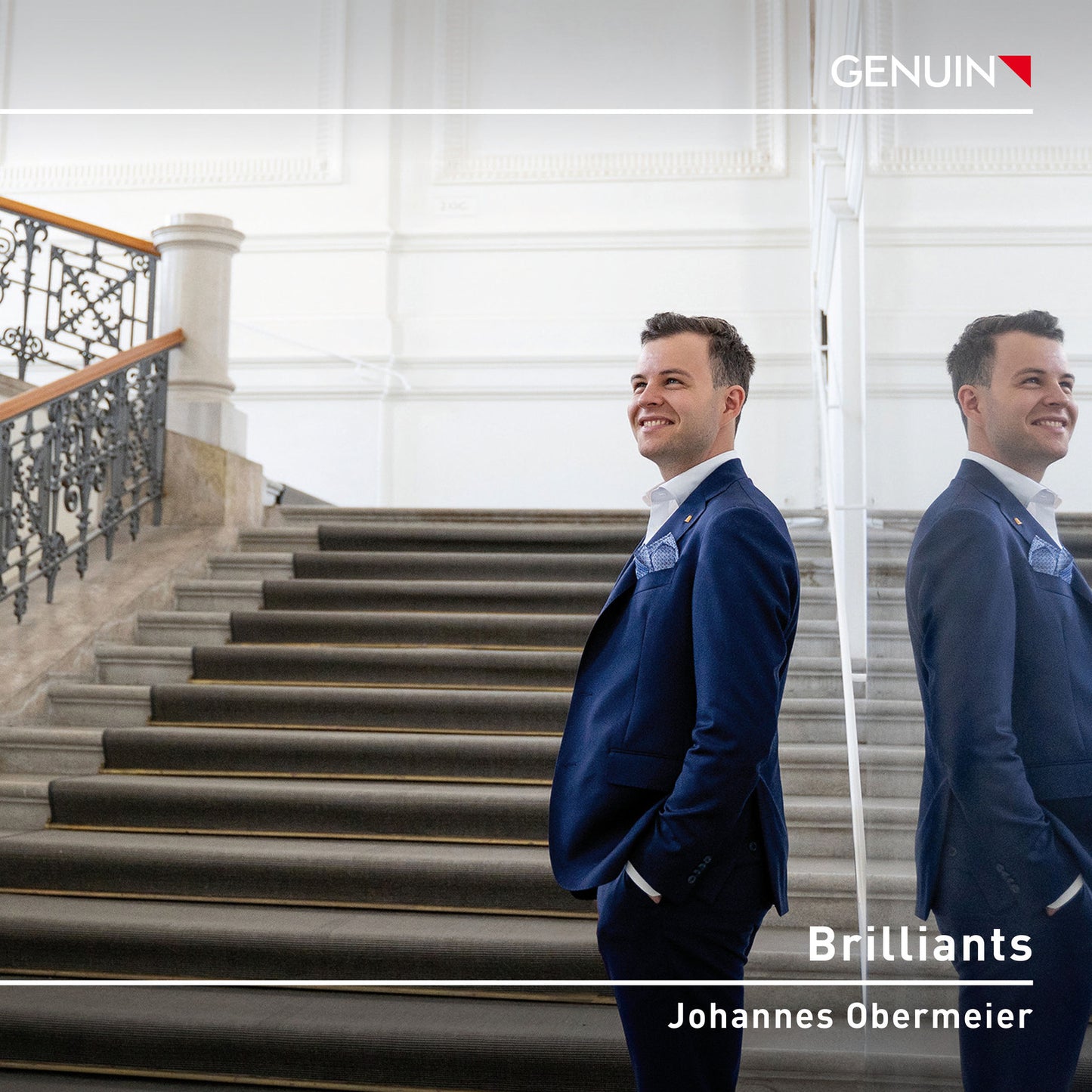 CD cover: Johannes Obermeier in a suit on a staircase.
