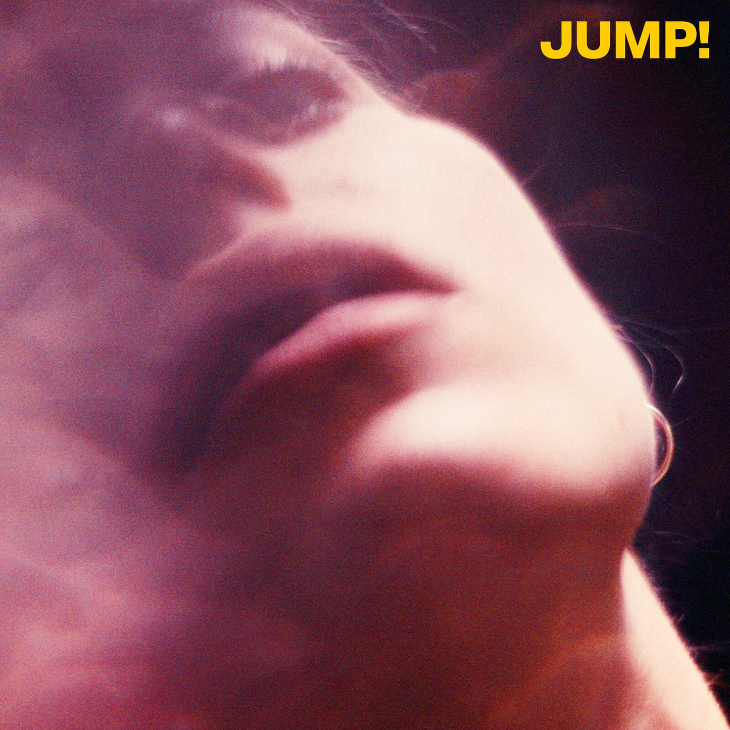 Close-up of a person’s face, with the album title “JUMP!” in yellow.