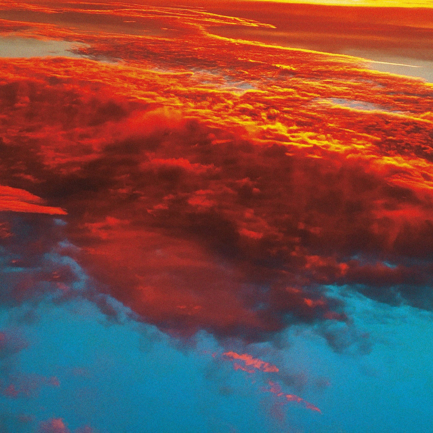 Dramatic, textured clouds in shades of red, orange, and blue.