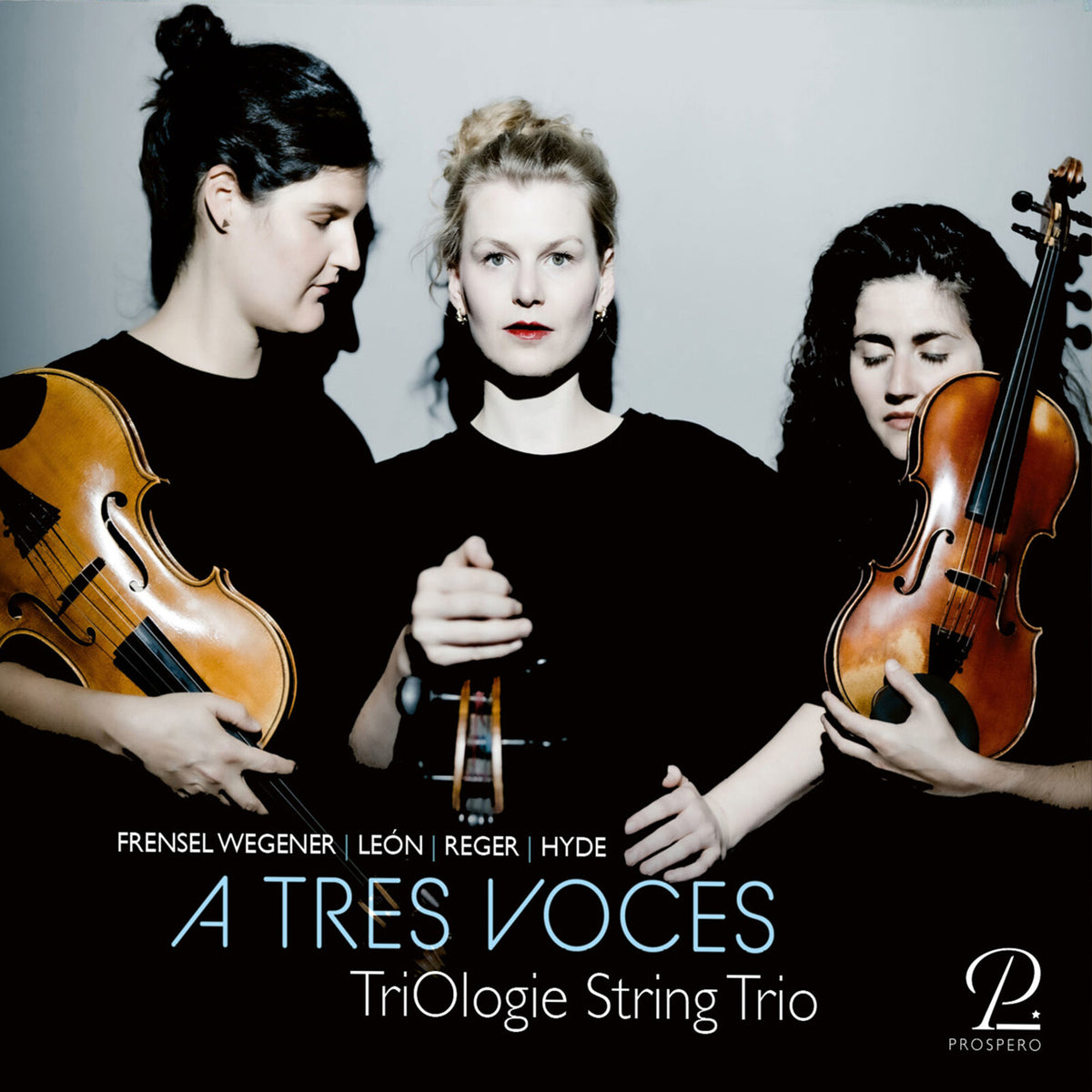 Three women playing violin, viola, and cello in a studio portrait.