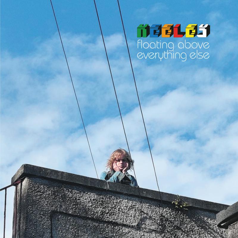 Person on a rooftop under power lines against a blue sky.