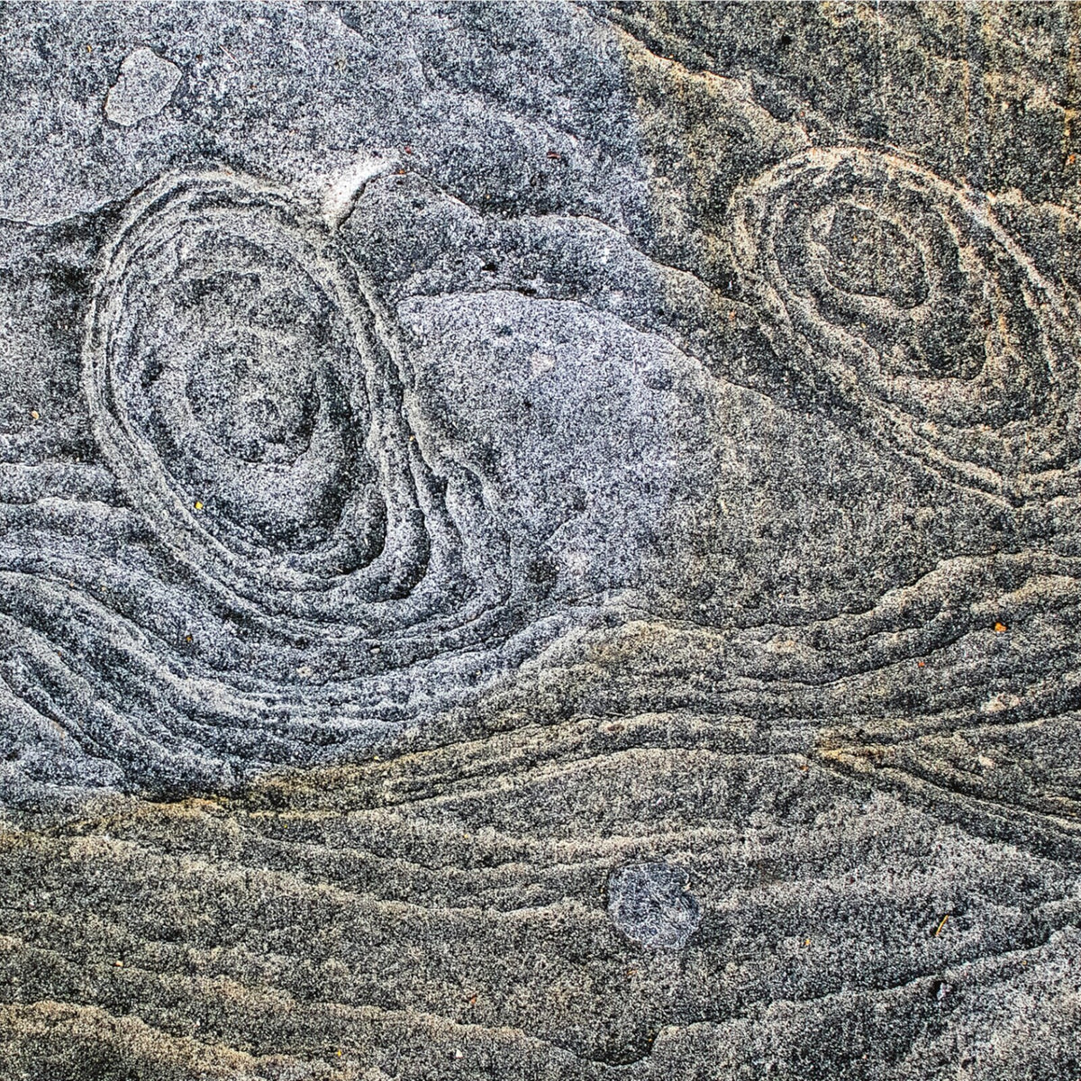 Swirling gray and blue patterns resembling water or sand textures.