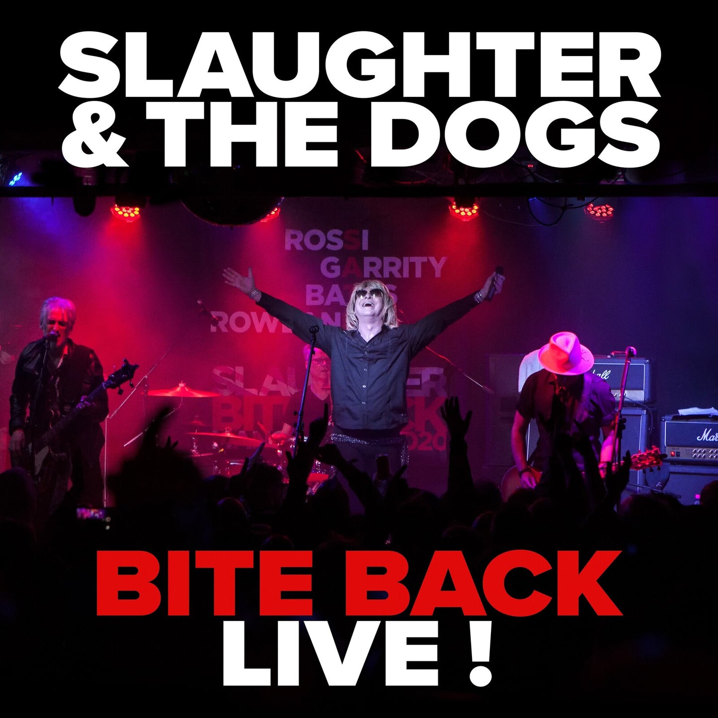 Slaughter & The Dogs live band performing on a dark stage.