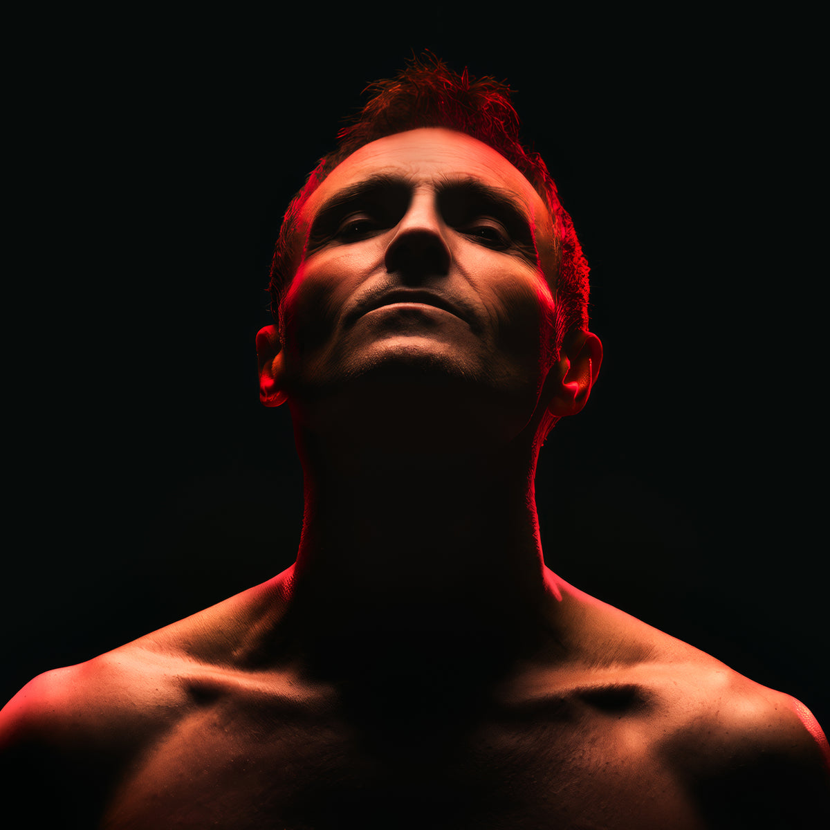 Marti Pellow portrait, looking up, illuminated by dramatic red lighting.