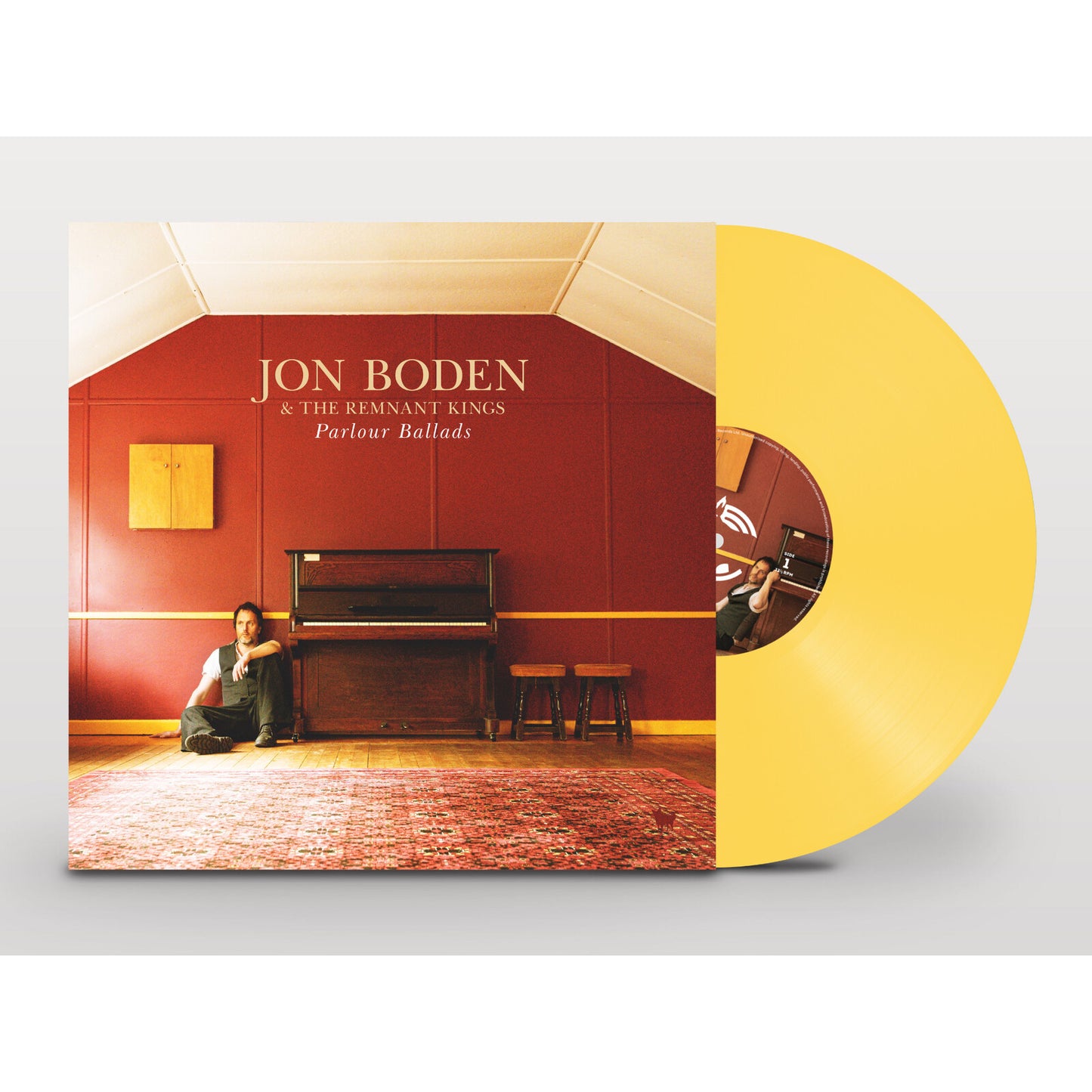 Yellow vinyl record with a red room and piano album cover.