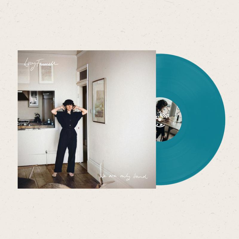 Vinyl record cover with a woman standing in a hallway, teal record.