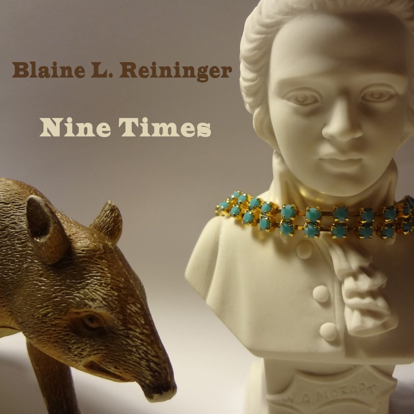 CD cover with a bust of Mozart and a golden armadillo.