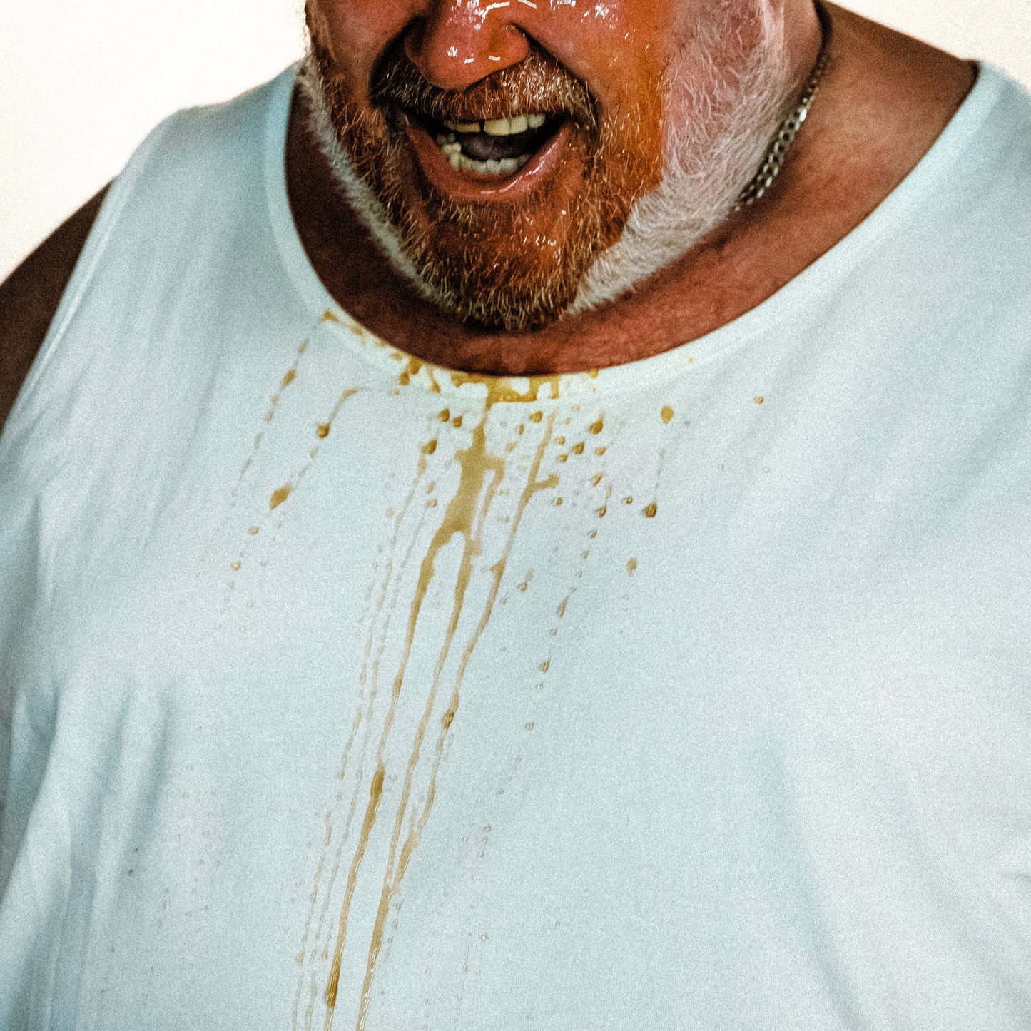 CD cover: Man with beard and stained white t-shirt.