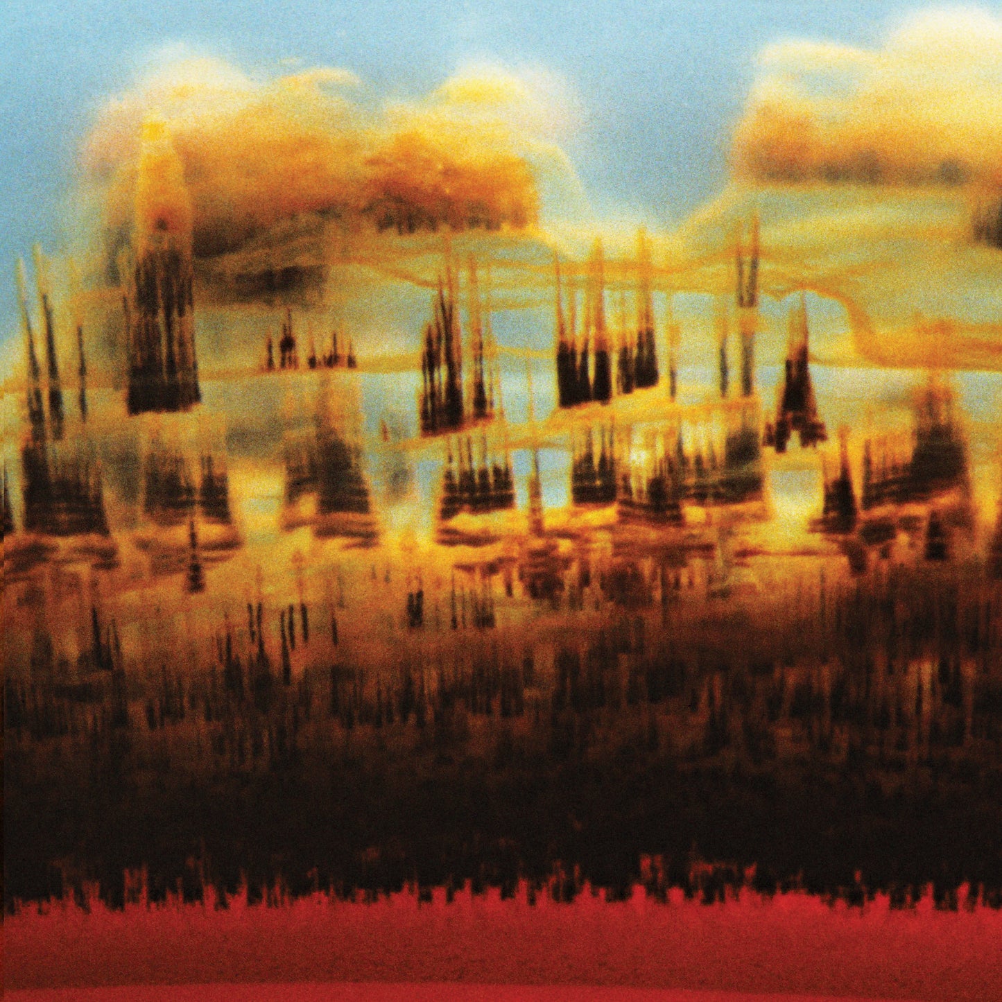 Abstract, blurred landscape in warm tones of orange, red, and blue.