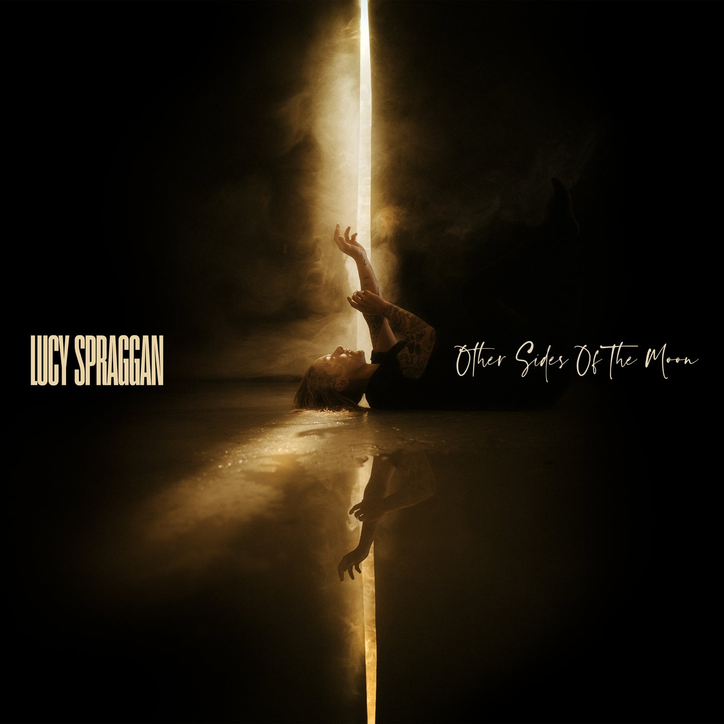 Album cover: Lucy Spraggan floating in water, dark and dramatic lighting.
