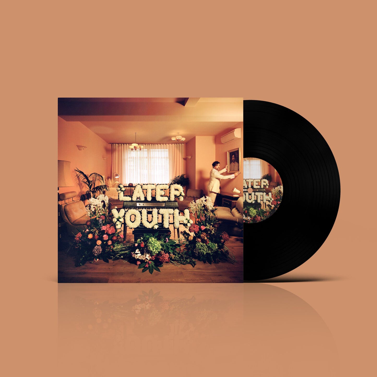 Vinyl record with album cover featuring a person and floral display.