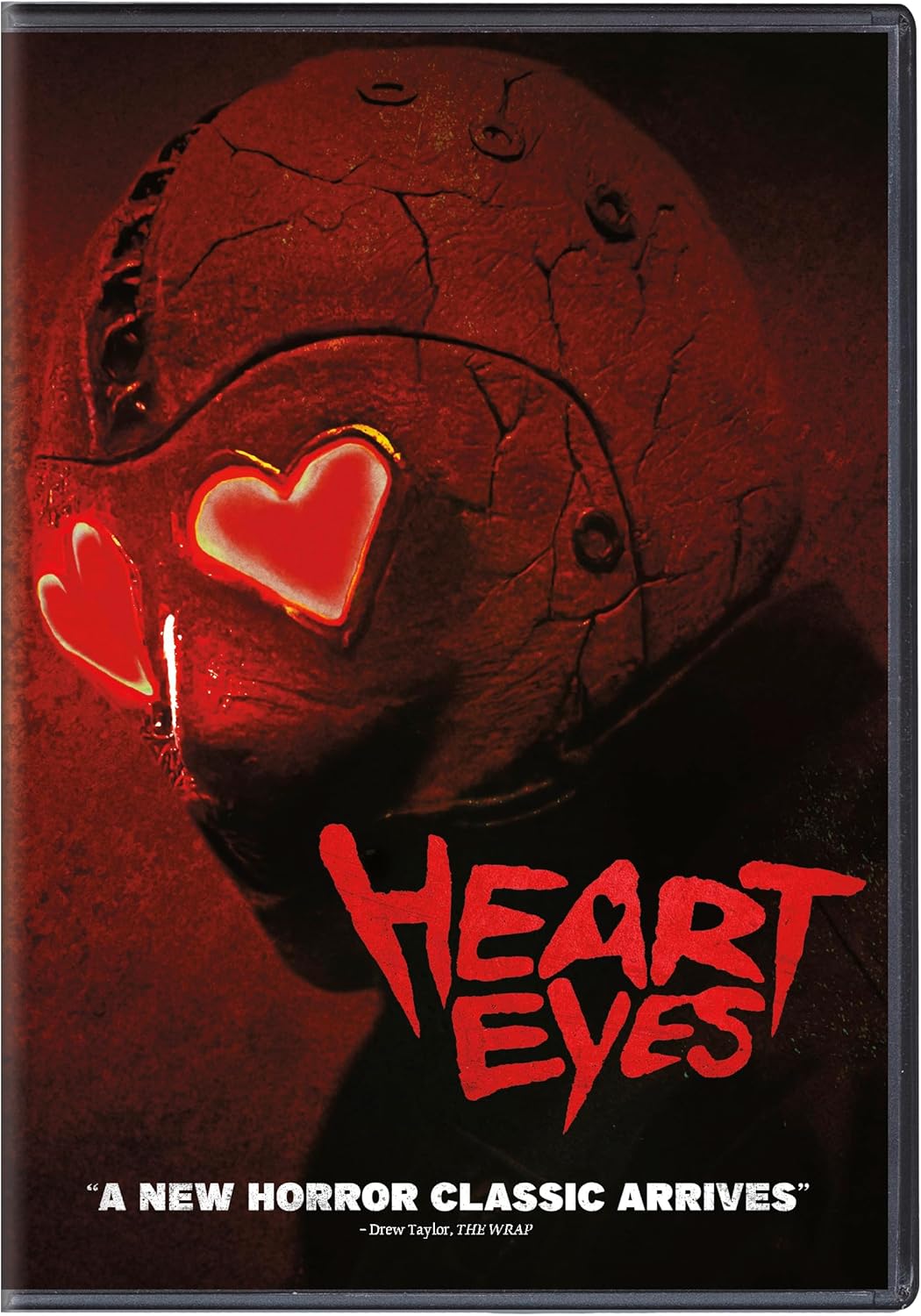 DVD cover featuring a cracked, red-lit mask with glowing heart-shaped eye cutouts.