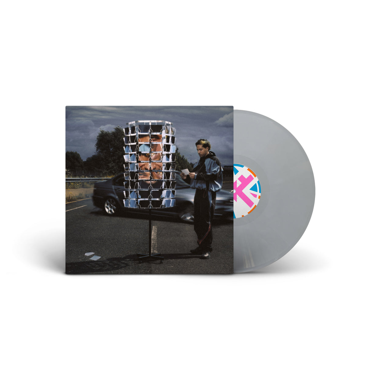 Silver vinyl LP cover featuring two figures near a roadside structure.