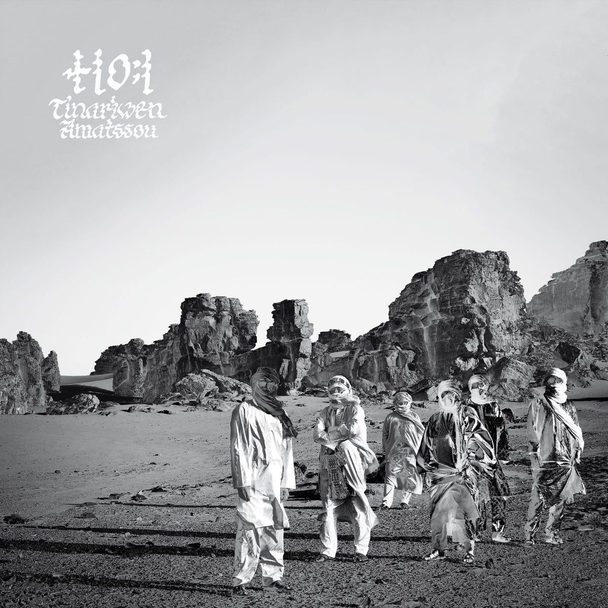 Tinariwen album cover: desert landscape with musicians in traditional dress.