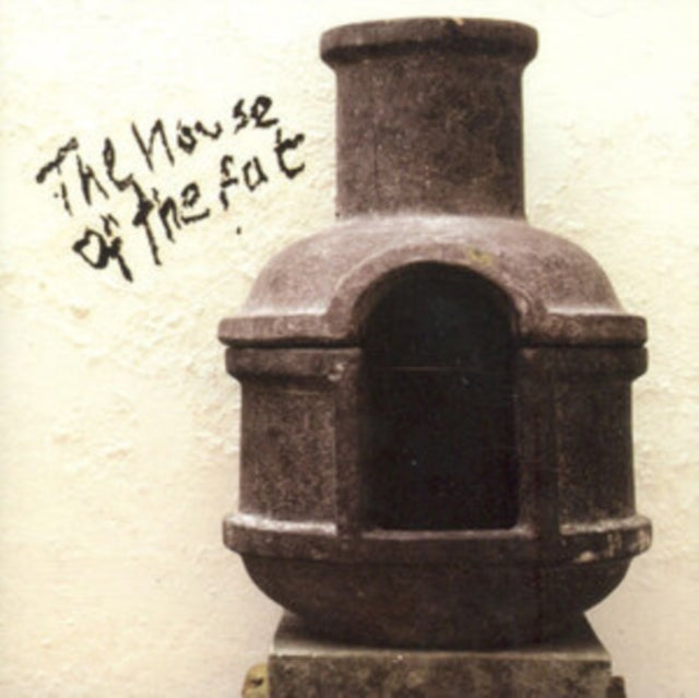 Stone building with arched doorway and handwritten text above.