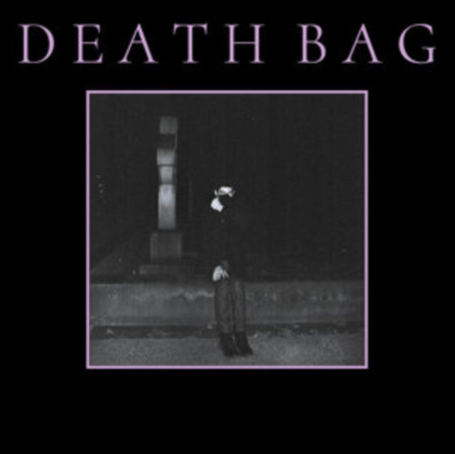 Dark album cover featuring a figure in a hooded robe at night.