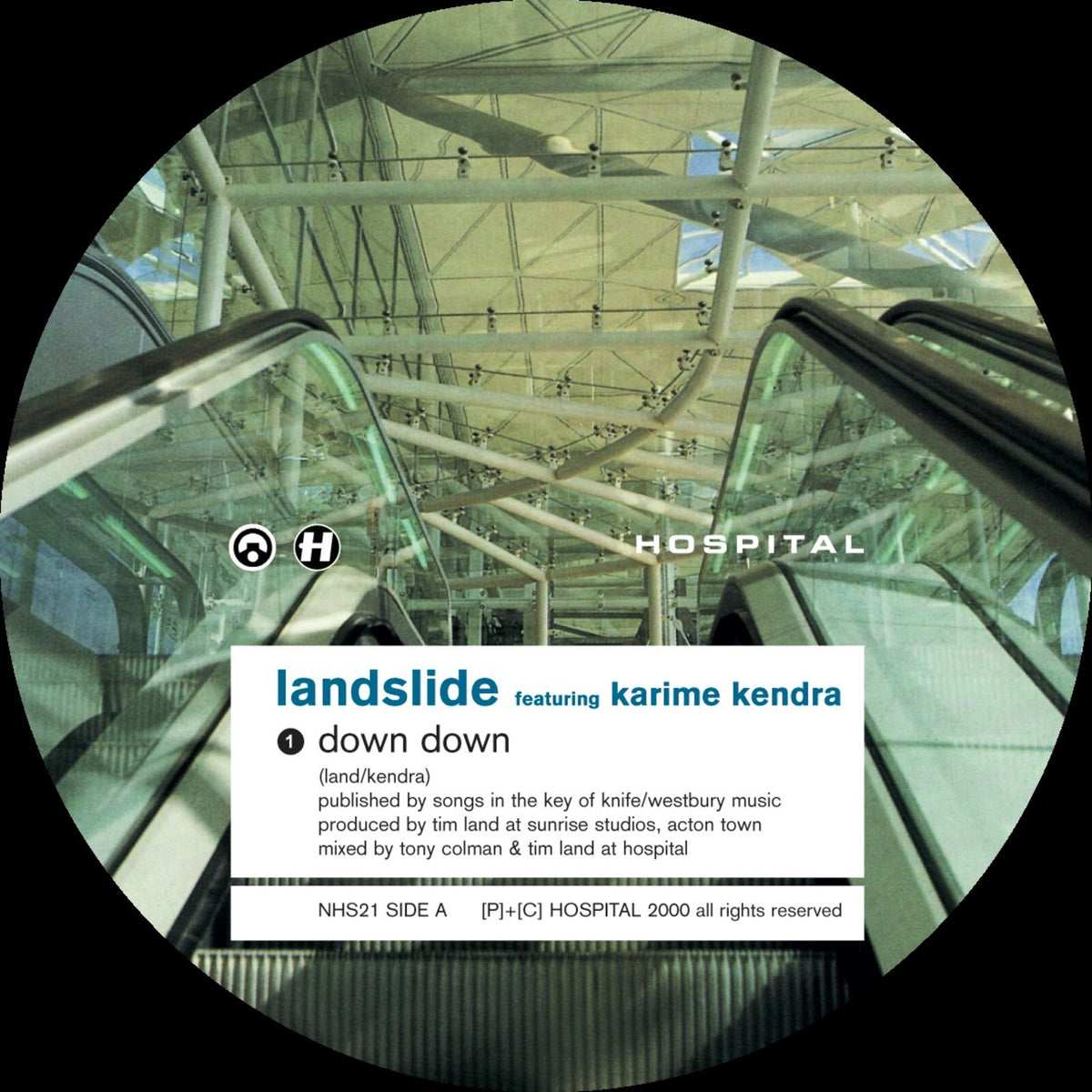 Vinyl record label for “Landslide - Down Down” with escalator image.