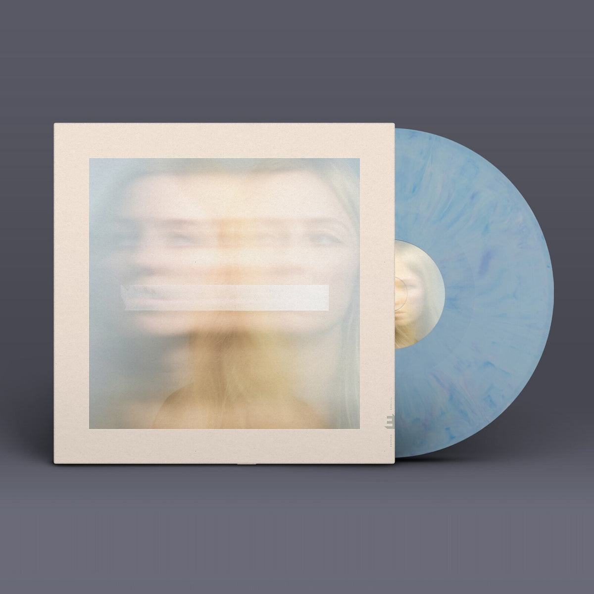 Vinyl record with blurred portrait cover and light blue marbled disc.