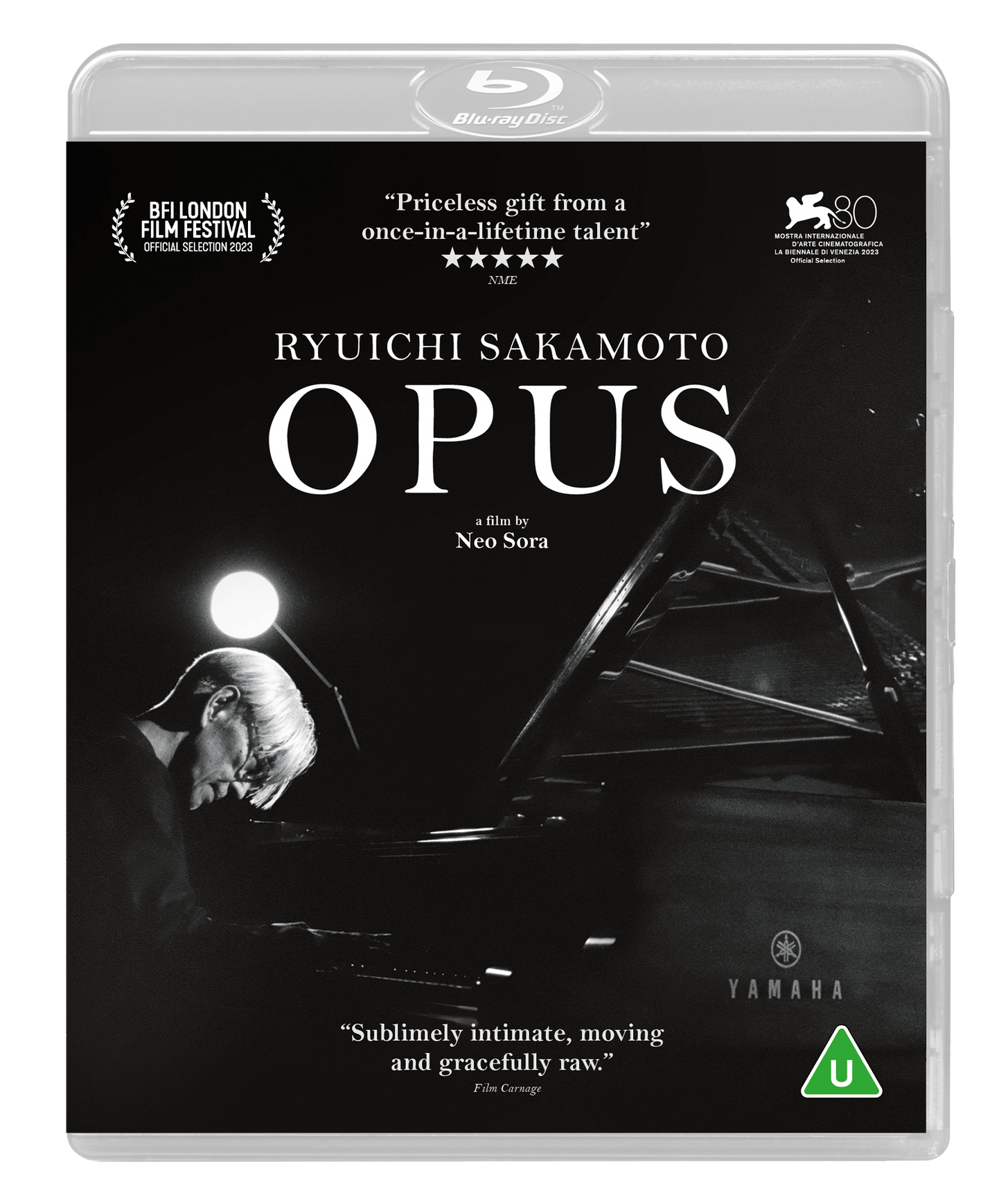 Black and white Blu-ray cover featuring Ryuichi Sakamoto playing a Yamaha grand piano.