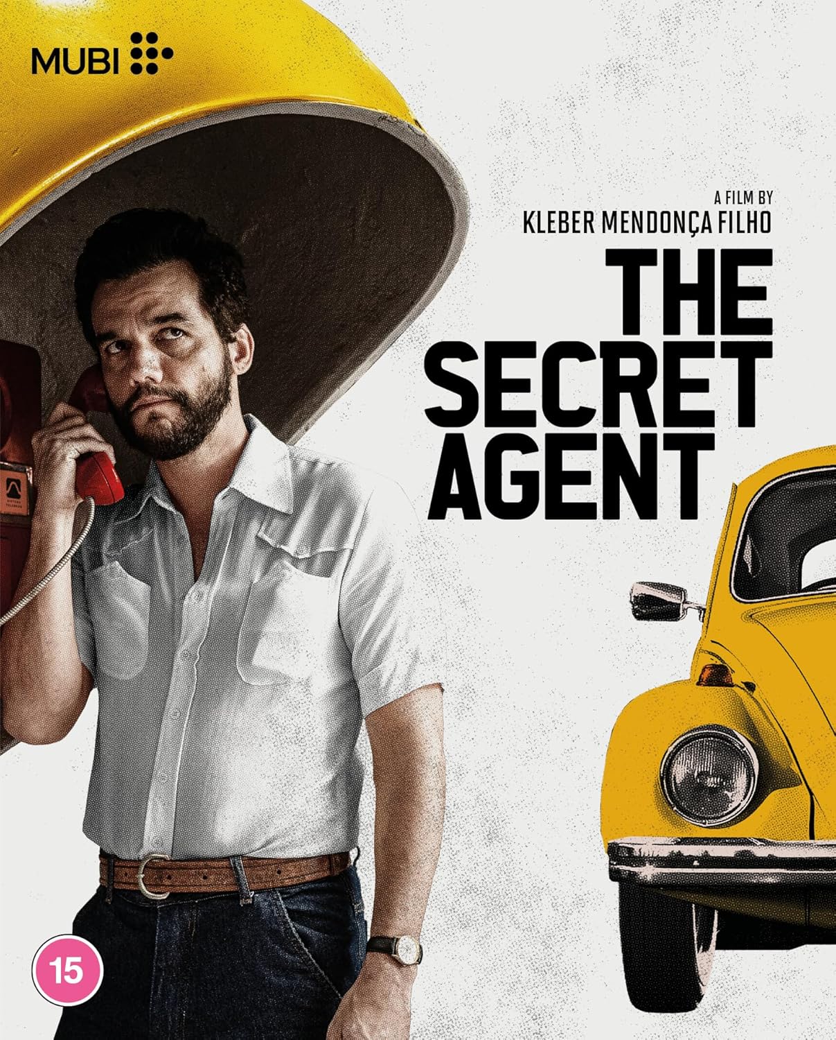 Man with phone, yellow car, and film title "The Secret Agent".