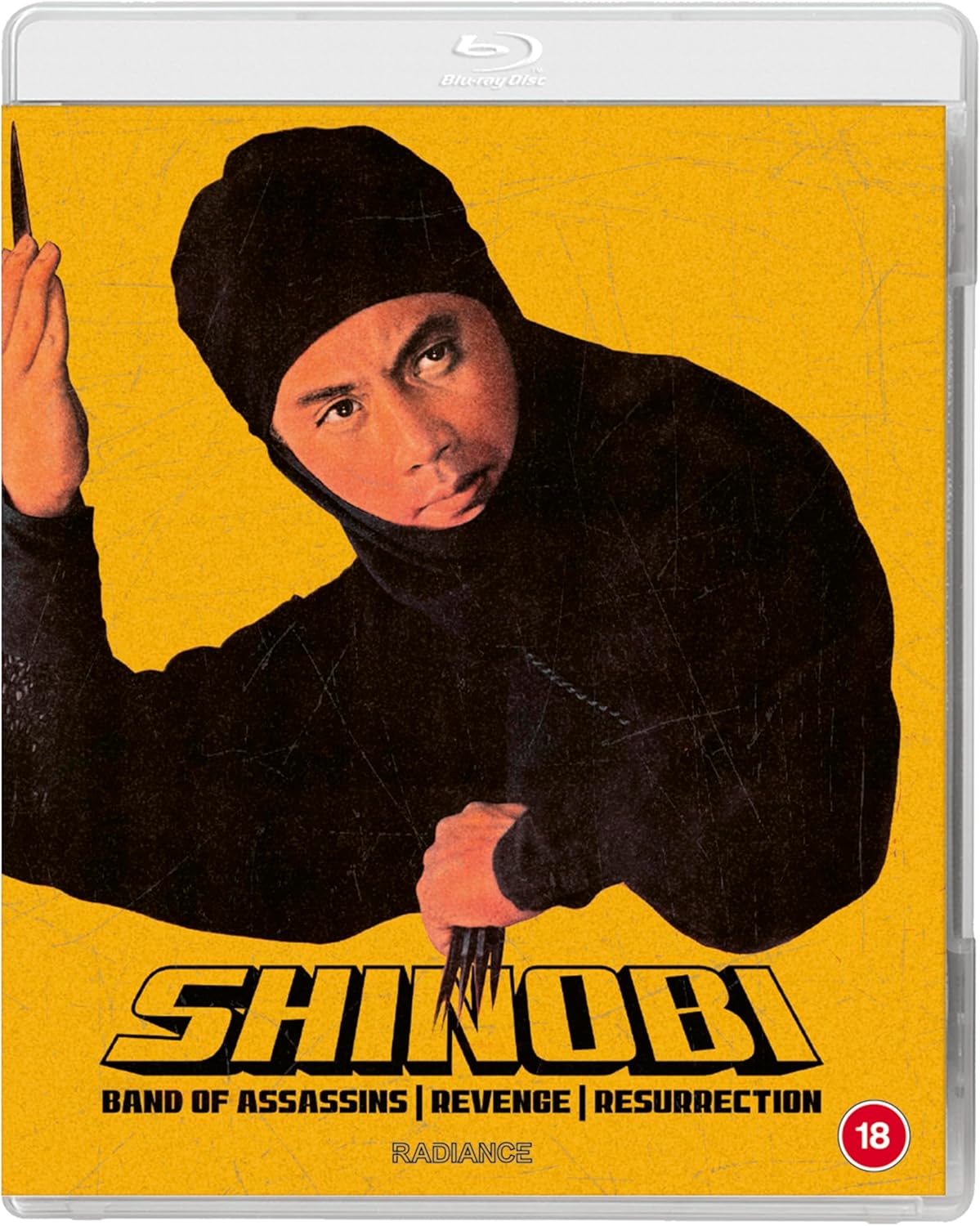 Blu-ray cover for "Shinobi" featuring a ninja in a yellow, textured background.