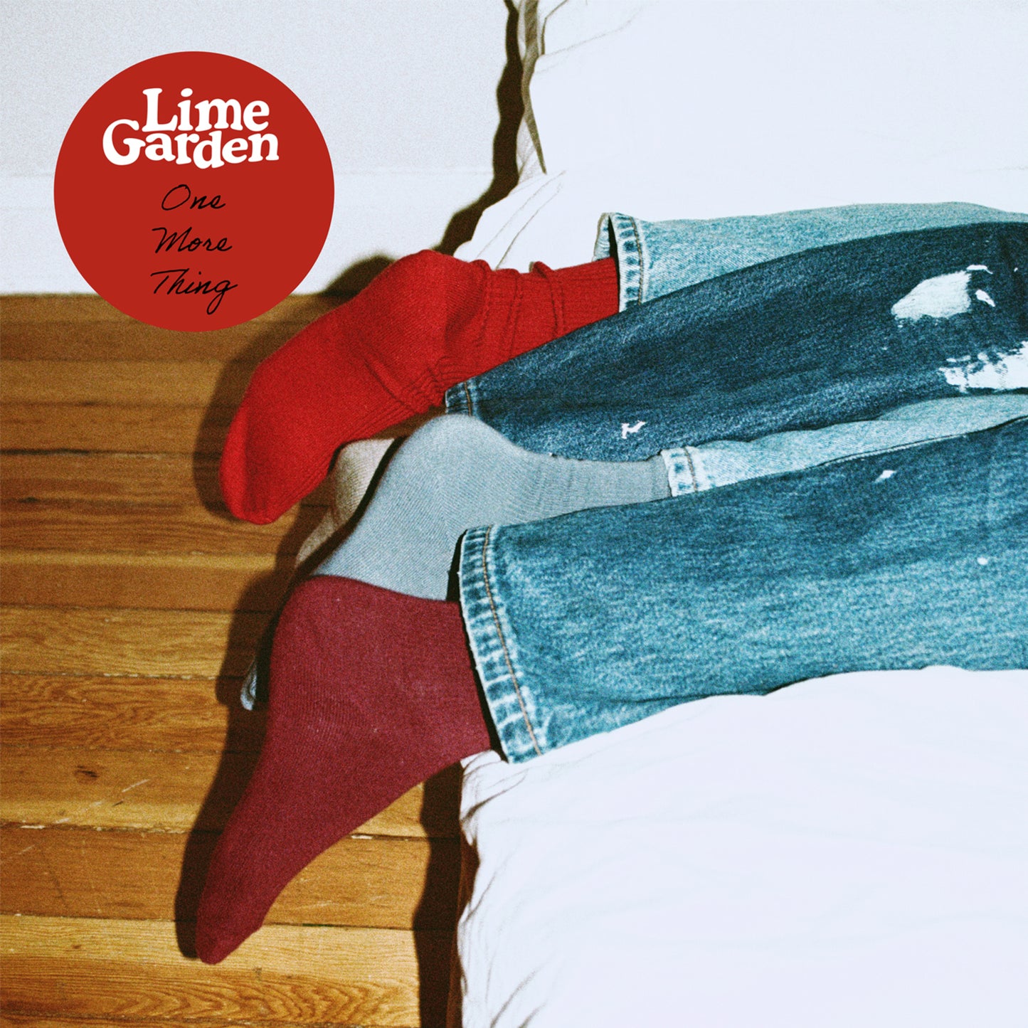 Vinyl album cover with legs in jeans and red socks.