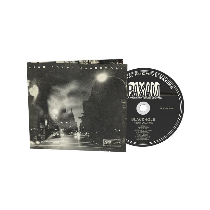 Ryan Adams' "Blackhole" CD and disc, with dark cityscape cover art.