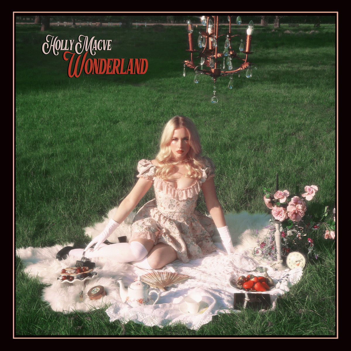 Holly Macve "Wonderland" album cover: woman on a picnic blanket.