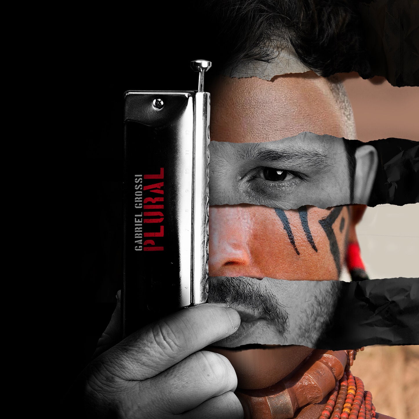 Hand holding harmonica obscuring a portrait with a torn effect.