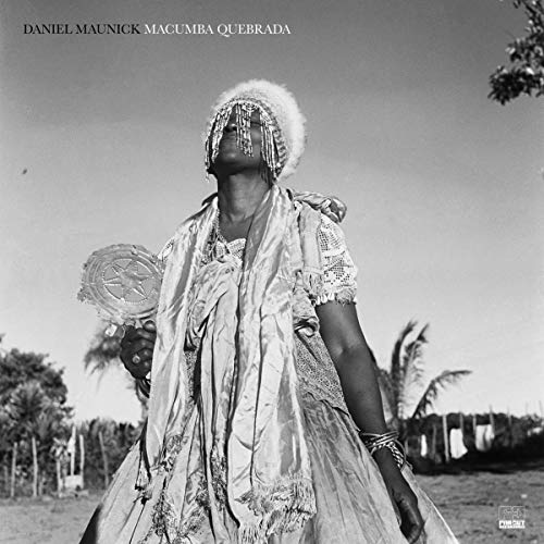 Black and white portrait of a person in ornate, traditional clothing.