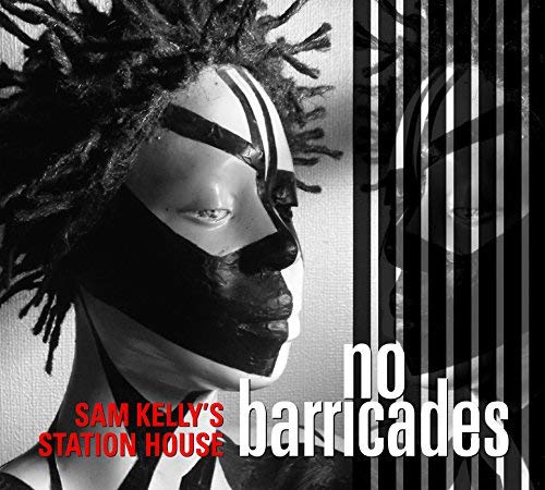 Black and white portrait of a person with face paint and dreadlocks.