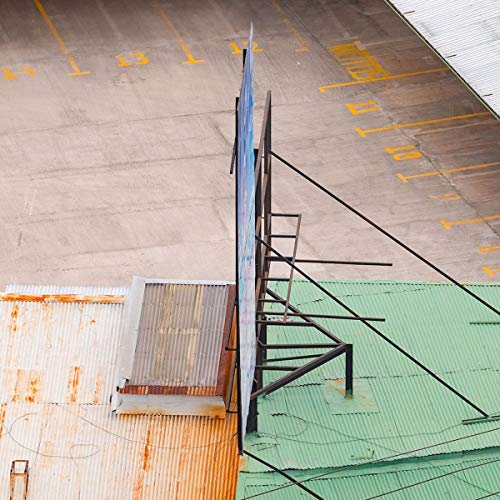 Vinyl record propped against a metal frame on rooftops.