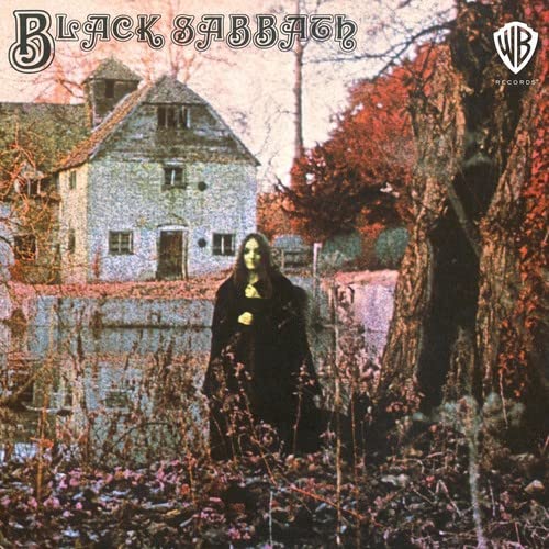 Black Sabbath album cover: a woman in black near a house.