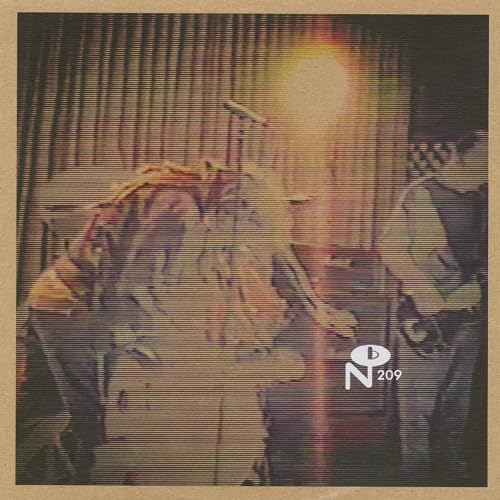 Blurred image of a band performing live, with a logo and number.