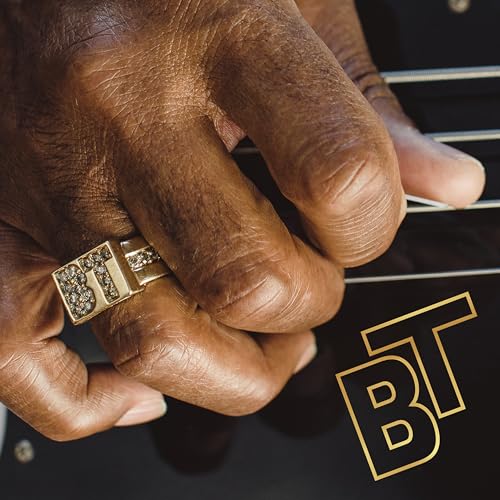 Close-up of a hand with a ring playing a guitar, album art.