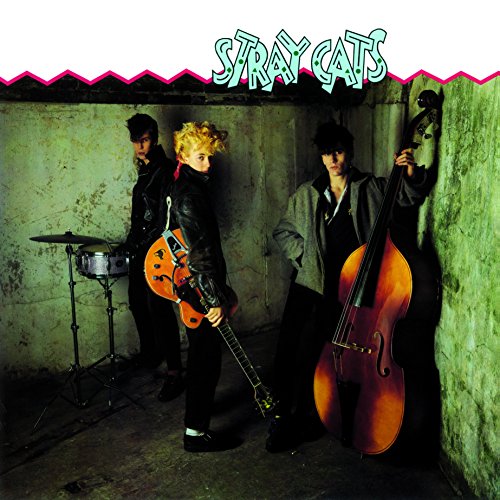 Stray Cats band portrait with guitar, bass, and drum set.