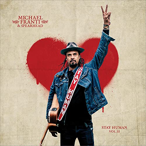 Album cover for Michael Franti & Spearhead’s “Stay Human Vol. II” featuring a man with a guitar.
